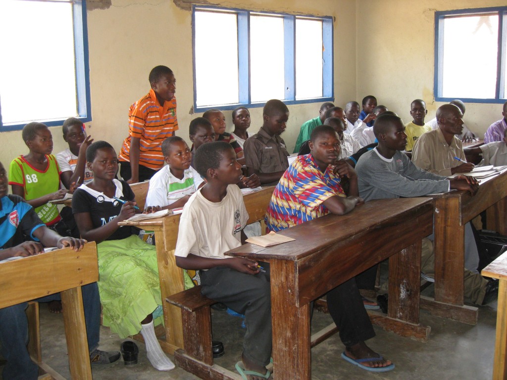 Crowded secondary school classroom after population influx.